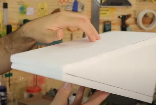 Cole as bases dos triângulos sobre as extremidades da placa base de 30 x 15 cm e depois a última placa retangular que foi cortada deve ser colada sobre a hipotenusa dos triângulos. Utilize cola de isopor.

a. Para garantir que estes pedaços de isopor não vão se deslocar enquanto a cola seca, utilize alfinetes para fixar as peças no lugar. Os alfinetes podem ser removidos após a cola estar seca.