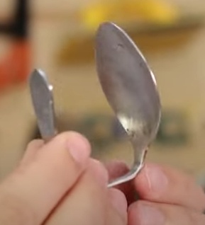 Dobre a colher duas vezes formando uma espécie de “C”, deixando a parte côncava da colher apontada para dentro.