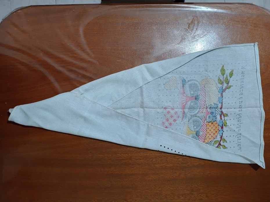 Dobre duas pontas do segundo pano de prato, formando um triângulo. Esse segundo pano direcionará a água do primeiro pano. A água escorrerá pela ponta amarrada.