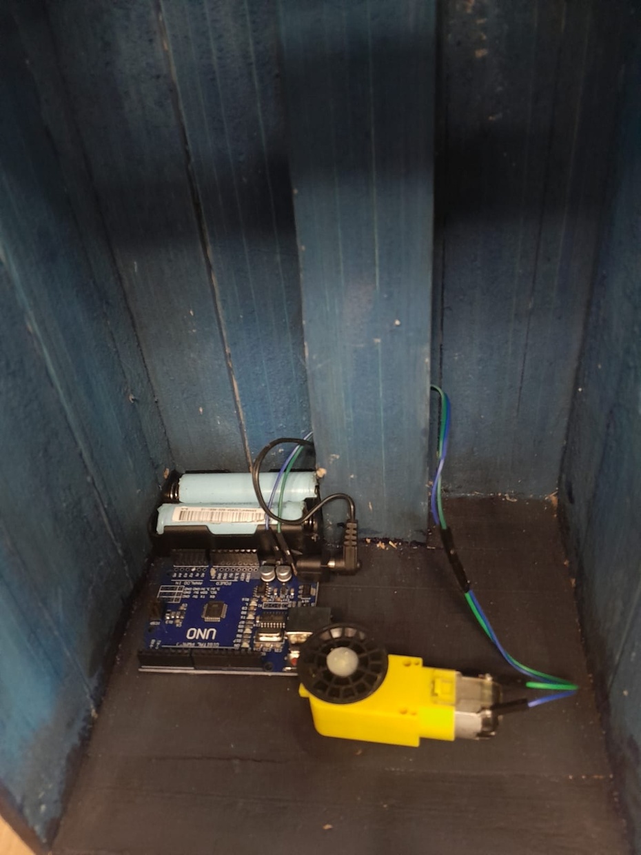 3 - Coloque o motor na parte de baixo (onde ficará a parte mecânica) o arduino no fundo com o botão dele para fora, coloque atrás do arduino o suporte de pilhas que dará energia ao nosso scanner.